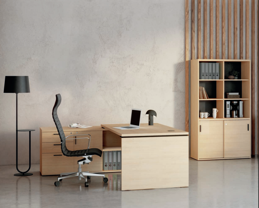Kara eol executive desk with storage units and a chair in an office setting, with the desk's surface clear except for a laptop and a notepad.