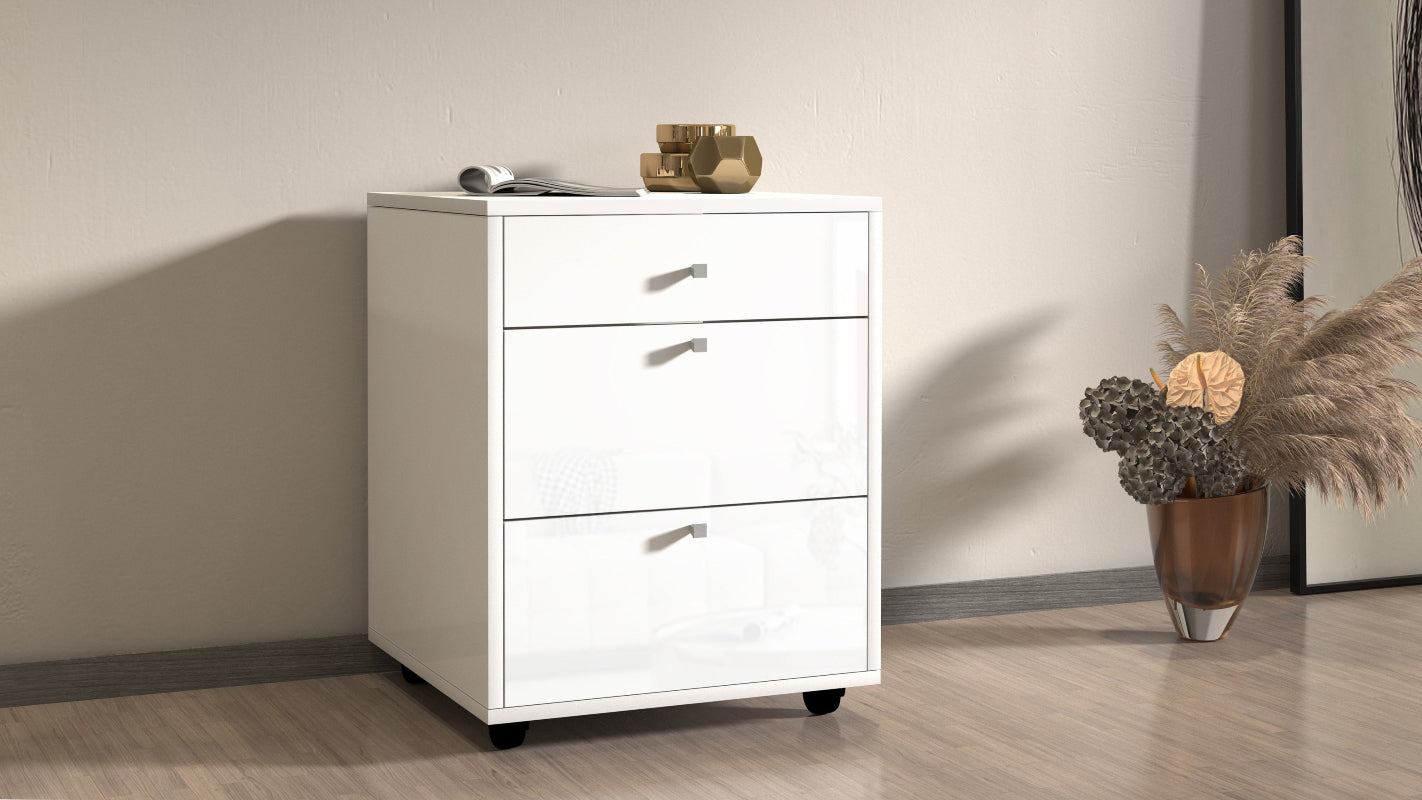DALIA 3-Drawer Mobile File Cabinet by Web Furniture, featuring rolling casters, lockable drawers for secure filing, and a compact design that fits beneath a desk. Ambiance picture. Glossy white.