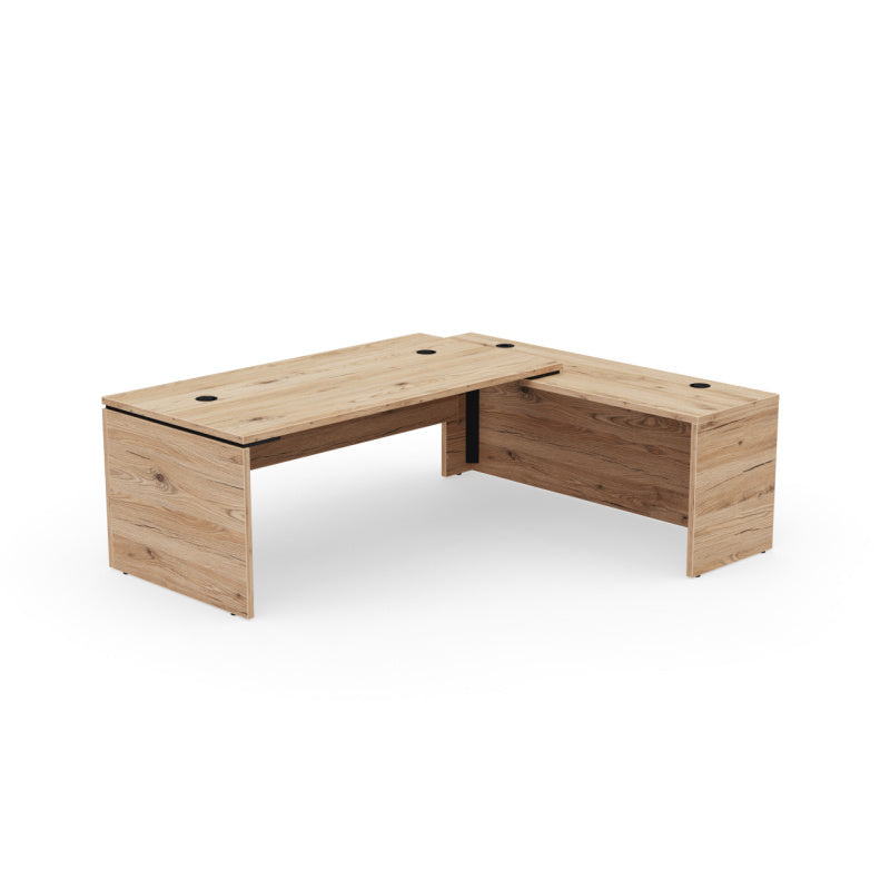 Kara Executive L-Shaped Desk (180x90 cm) with extended return panel on the right side, featuring durable melamine construction and superior integrated power/USB cable management for a streamlined professional office. Brunswick oak.
